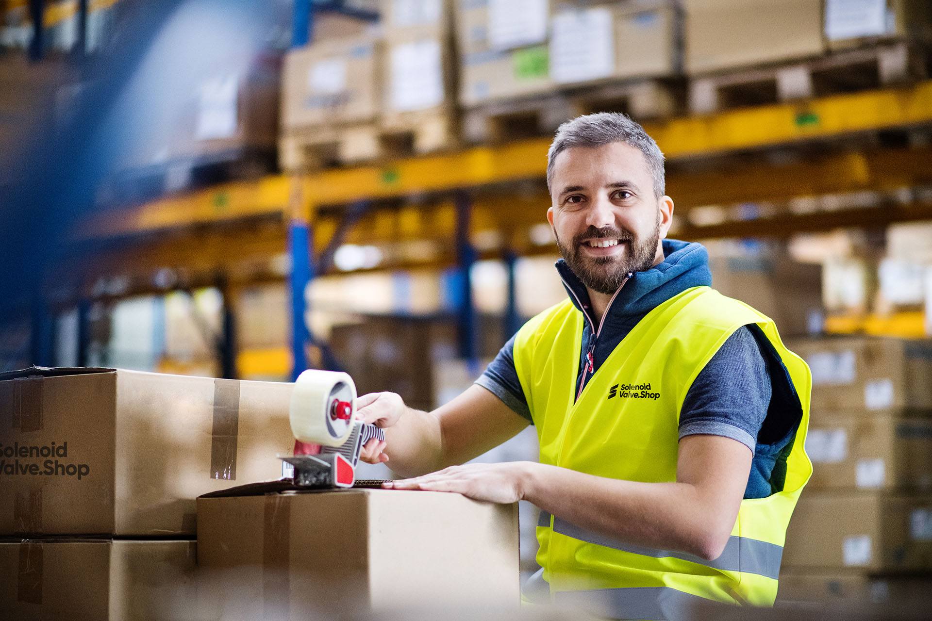 Solenoid Valve Shop employee packing boxes